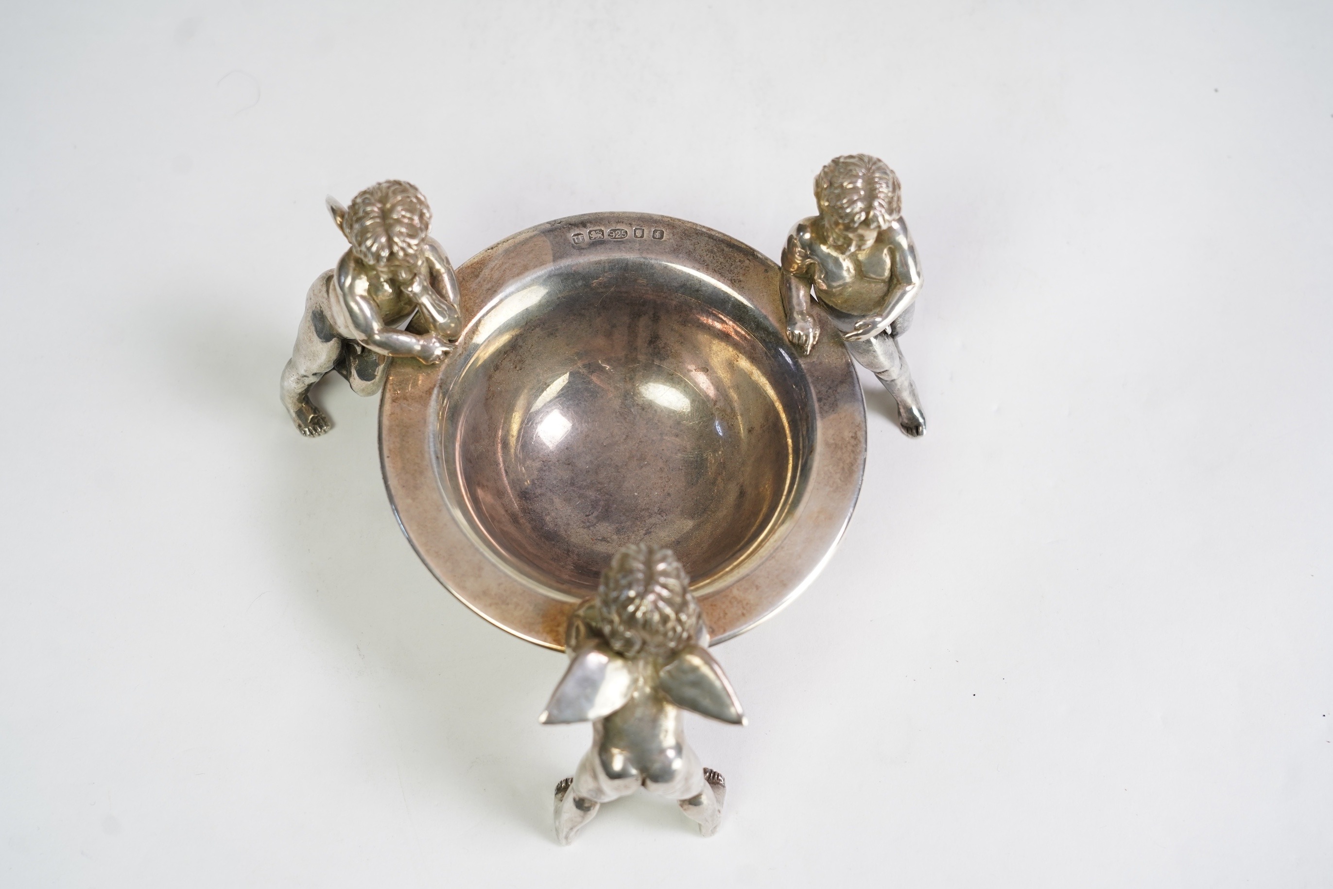 An Elizabeth II Theo Fennell silver bonbon bowl, with three cherub supports